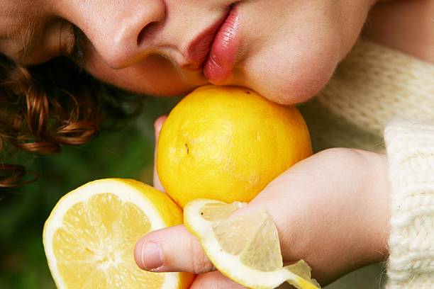 Woman using lemon to boost her beauty