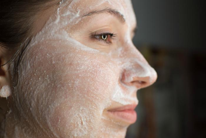 Woman using aspirin on her face