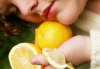 Woman using lemon to boost her beauty
