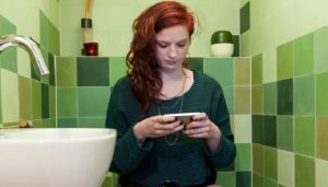 Woman with phone in the bathroom
