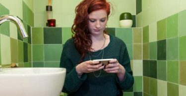 Woman with phone in the bathroom